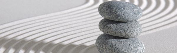 Smooth stones stacked in Zen raked garden Smooth stones stacked in Zen raked garden